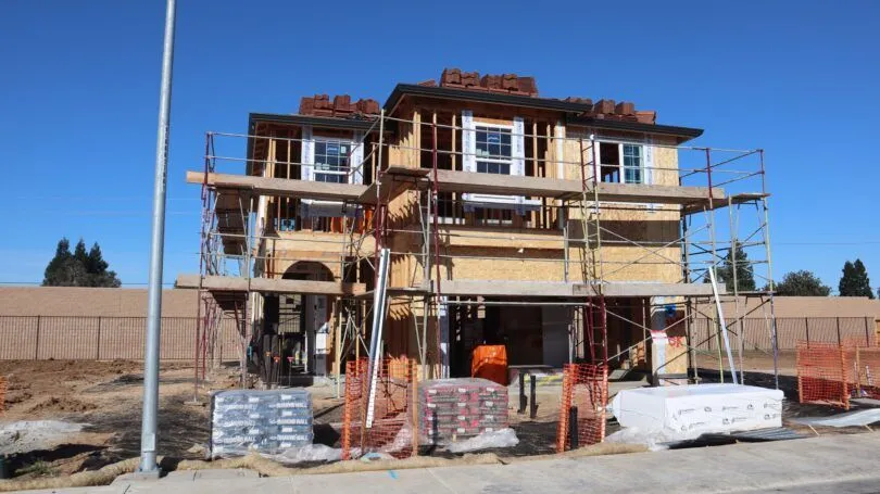 Buyer viewing a new-build property while arranging a mortgage before completion.