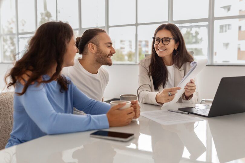 A picture of a young couple agreeing a second charge mortgage loan