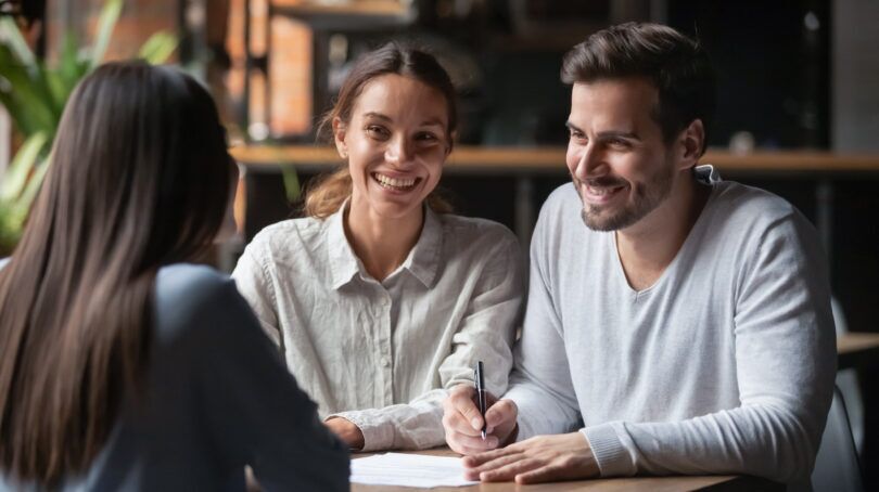 Young UK couple receiving first-time buyer mortgage advice from broker