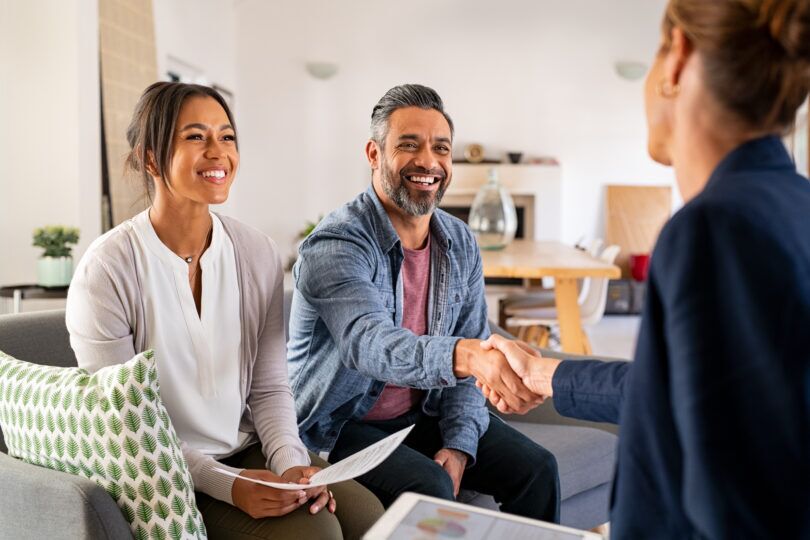 Foreign national couple meeting with mortgage advisor in a UK home setting